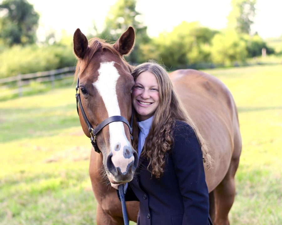 Senior Sammy West  poses with her horse for a senior photo session.