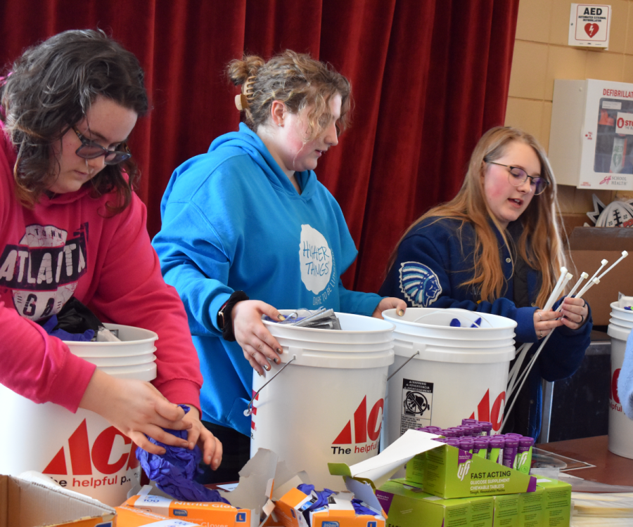 Key Club students add finishing touches to the emergency buckets.