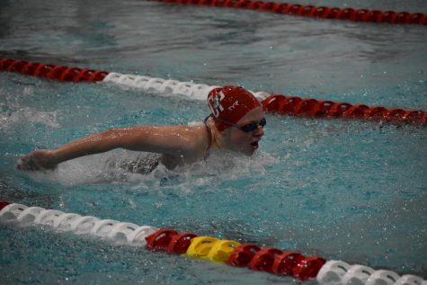 Freshman Kaitlin Flewelling executes the butterfly stroke during a home meet.