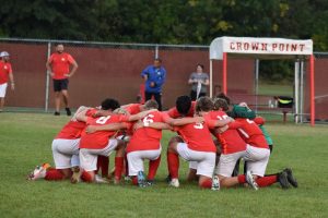 The Boys Varsity Soccer Team participates in their traditional pre-game prayer.