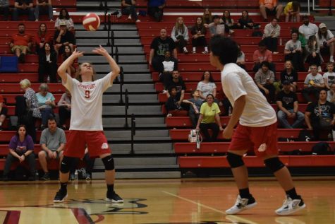 (Left) Freshman Mason Isom sets the ball. Isom is a right-side hitter and a setter for the JV team.