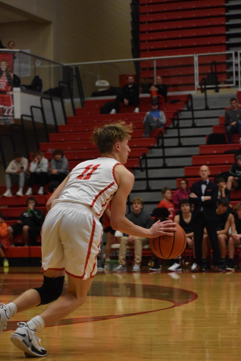 Senior Elliot Swan dribbles the ball down the court. He wears his longtime number, 11.