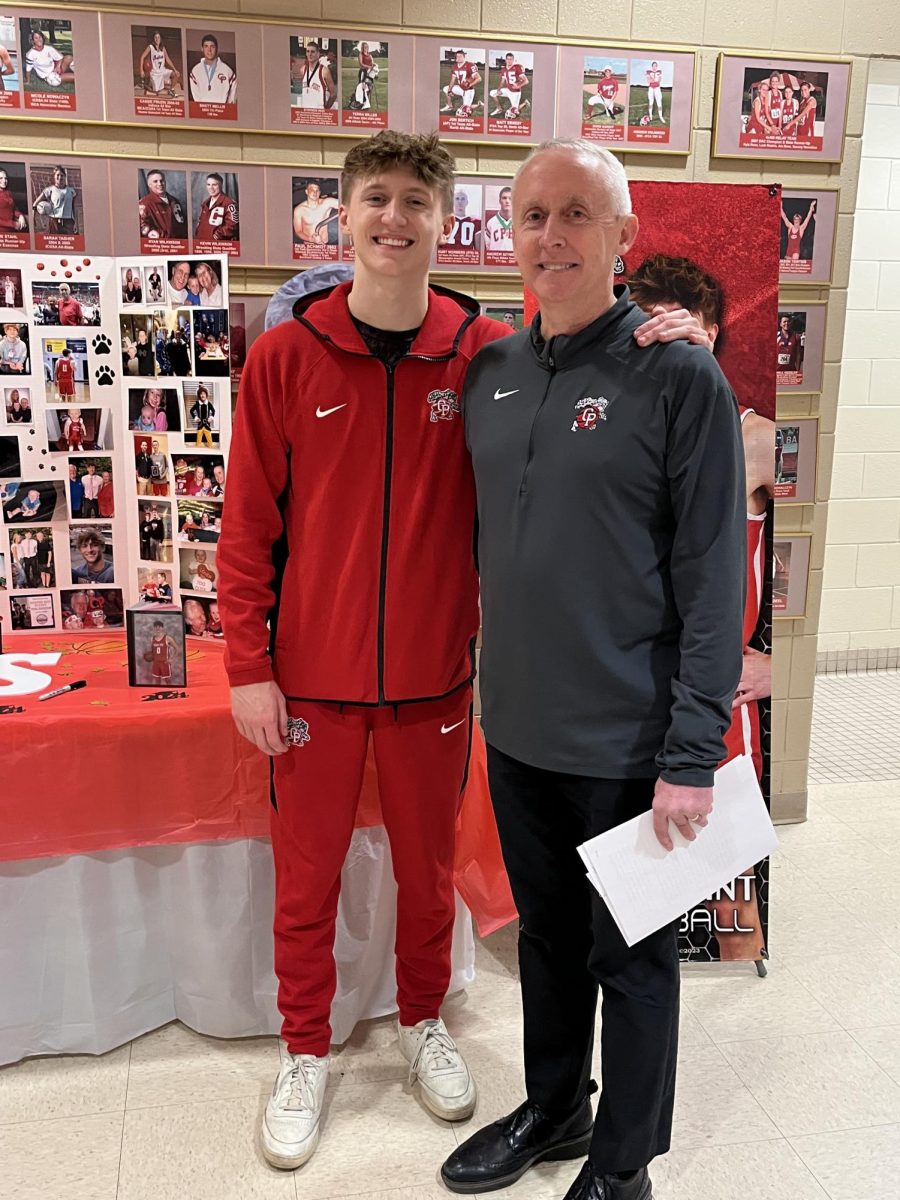 Elliot Swan (left) and Coach Swan (right) pose for a picture together. 