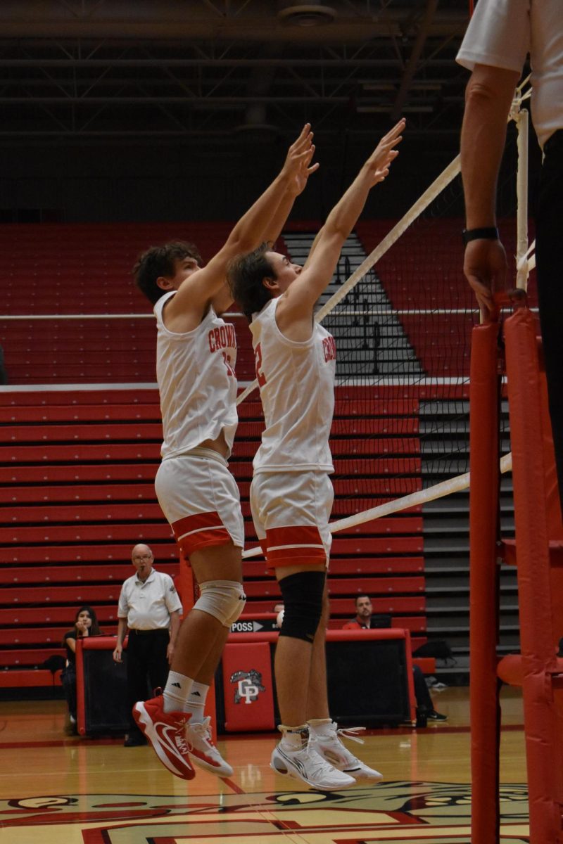 Stephen Szala and Mike Brutto block the ball from getting over the net