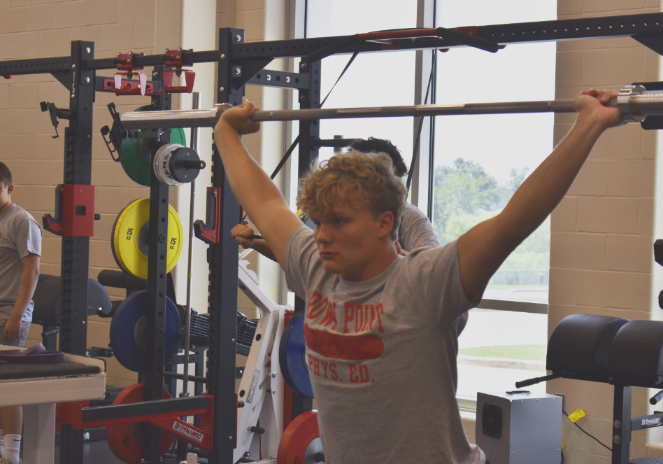 Junior Logan Deeb performs a power jerk.