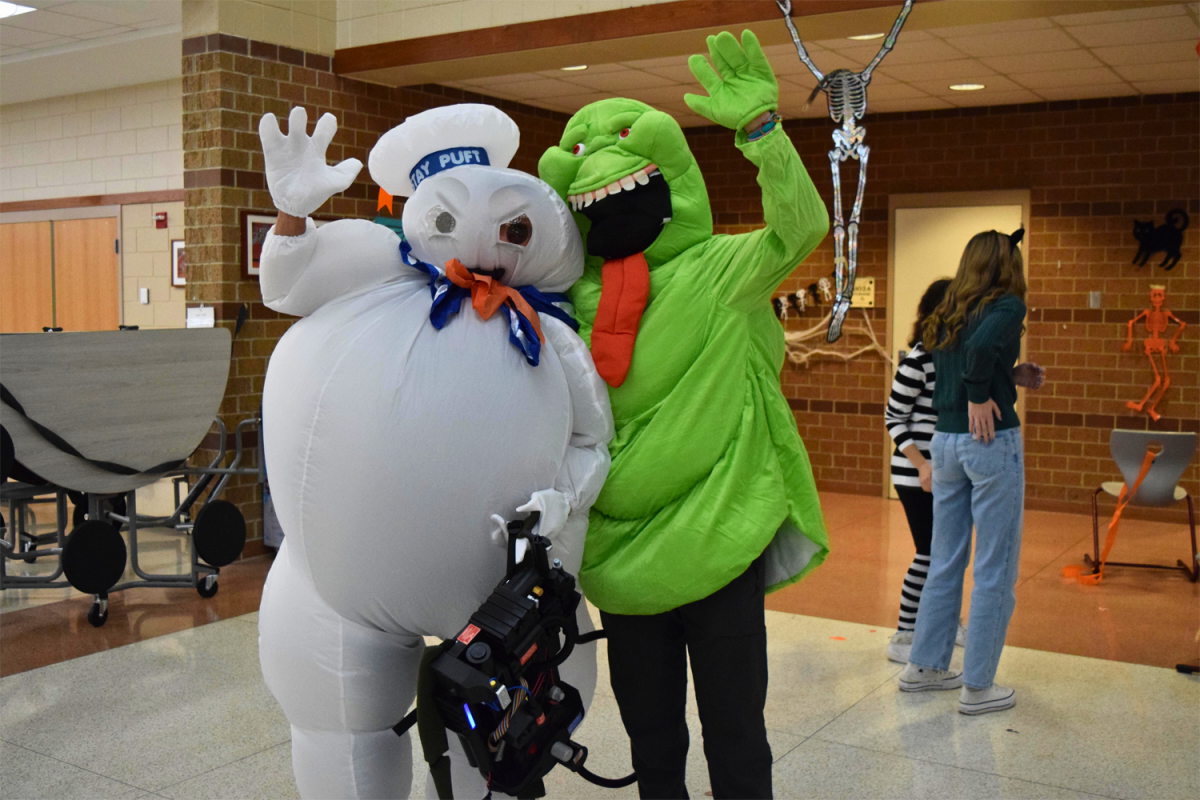 Ghostbusters characters wave towards the camera