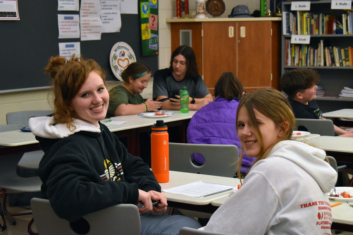 German club members smile at the camera during the meeting.