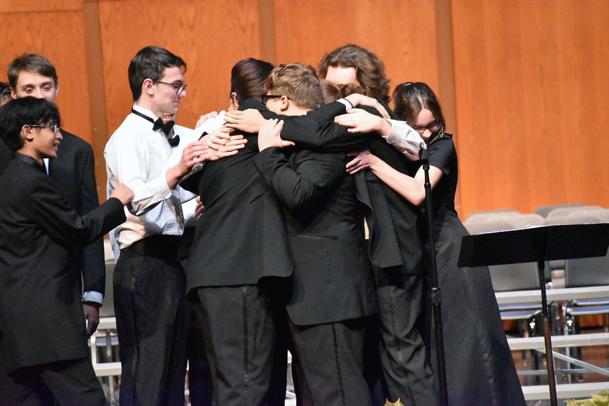 Choir seniors hug at the end of the concert.