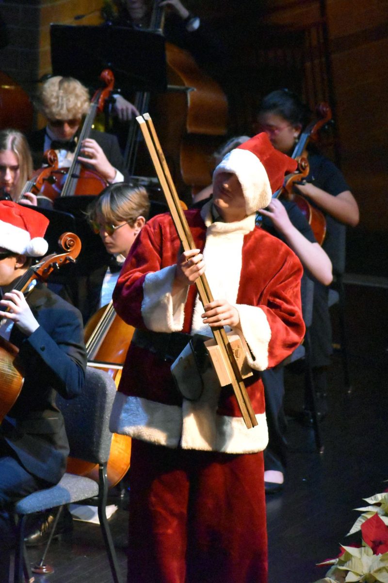 William Bests (12), dressed up as Santa, adds the slapstick to the song "Sleigh Ride."