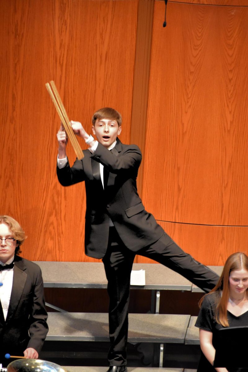 Tyson Abraham (10) plays the slapstick during "Sleigh Ride."