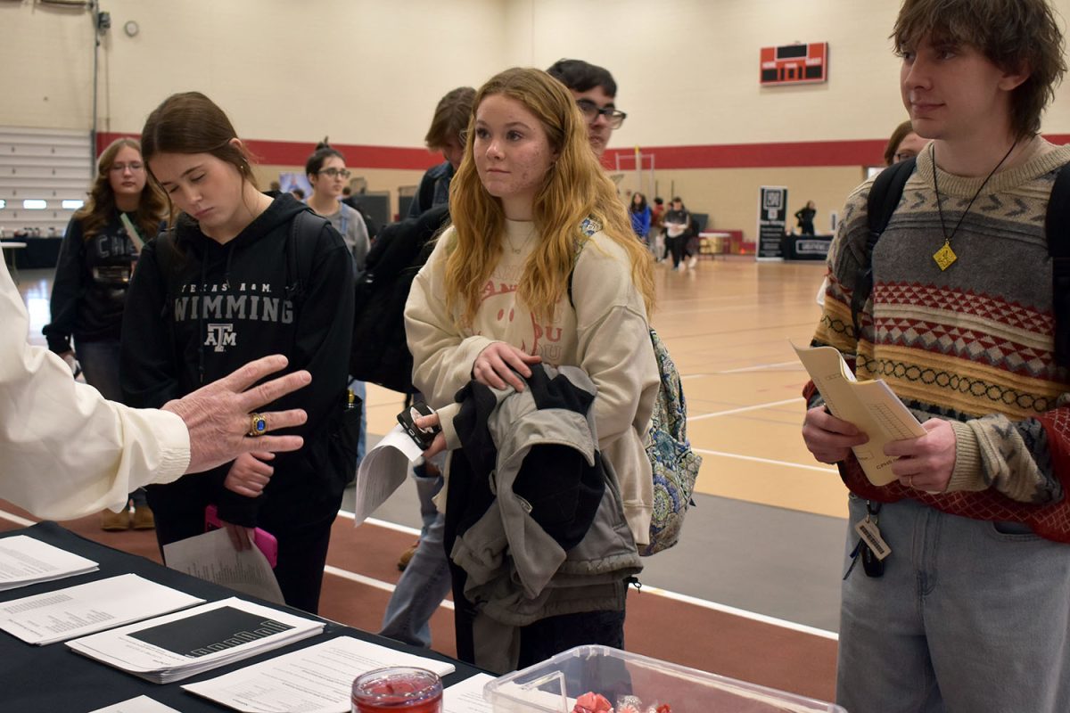 A student stops at the CPHS education booth.