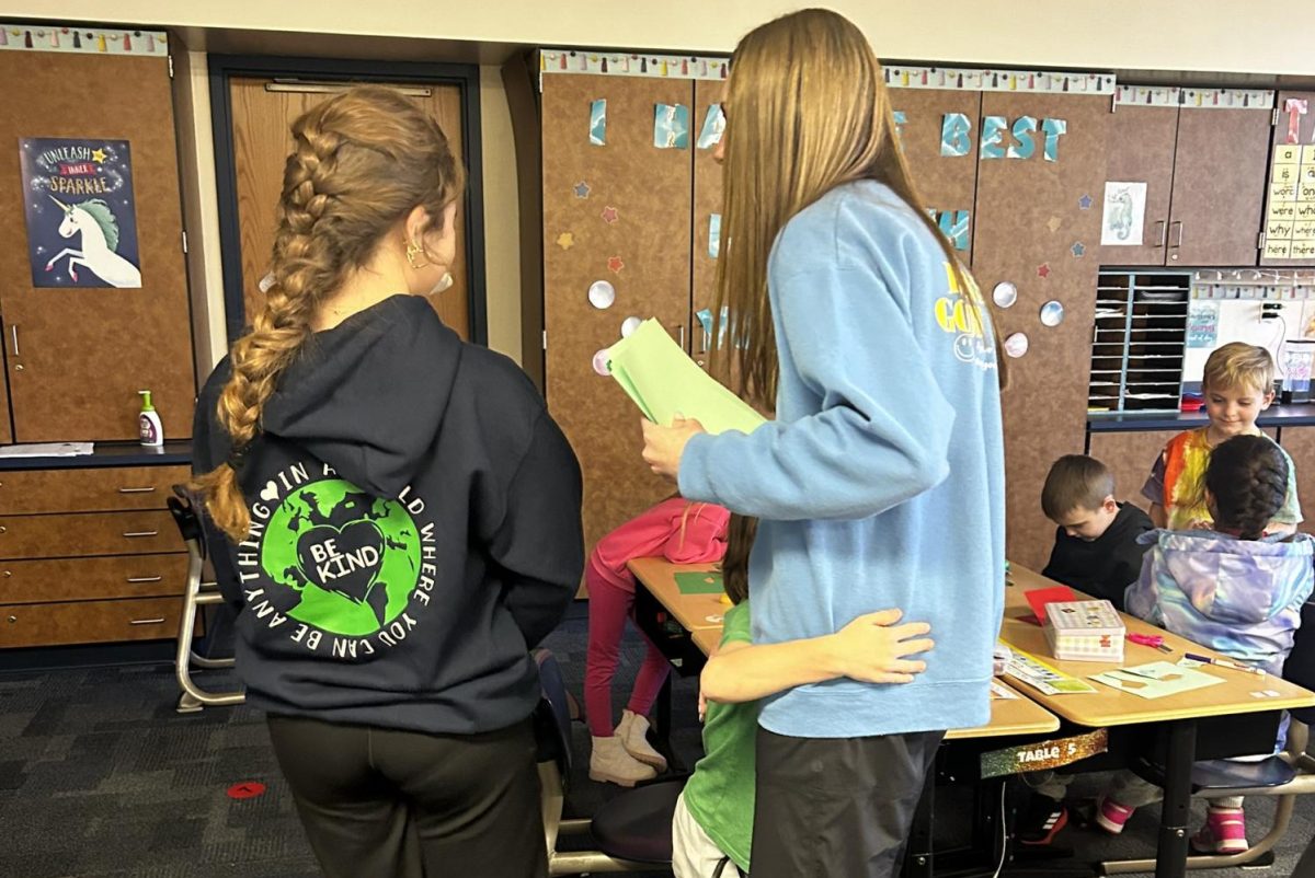 Lily Bajda (9) accepts a hug from an elementary student.