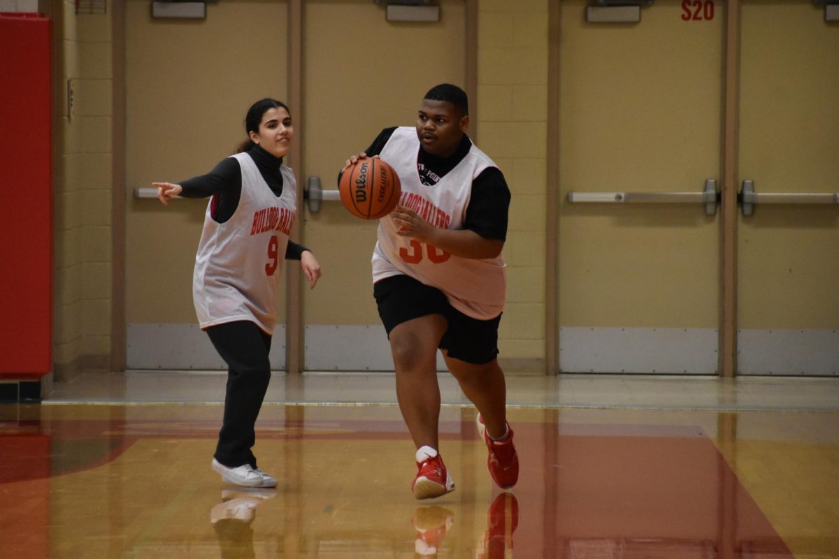 Samson Clemons (18-23) runs to shoot a hoop.