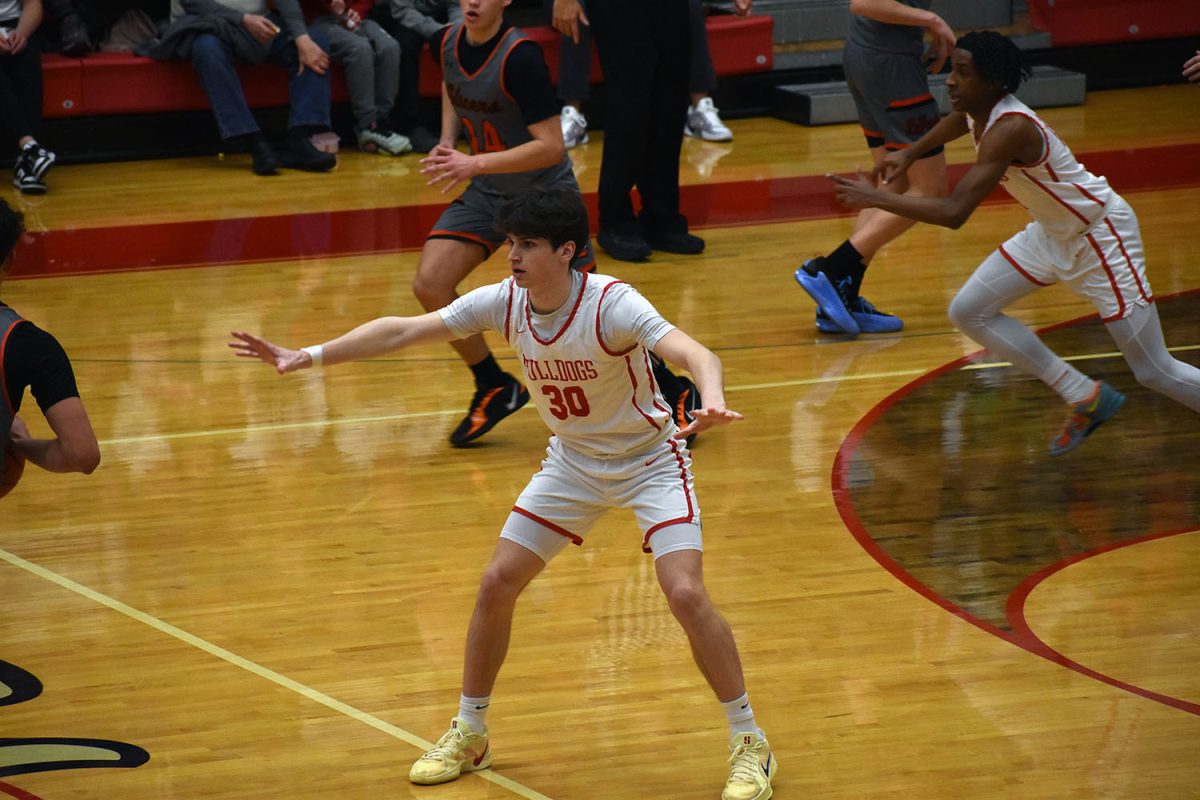 Quinn Begley(12) defends his side of the court