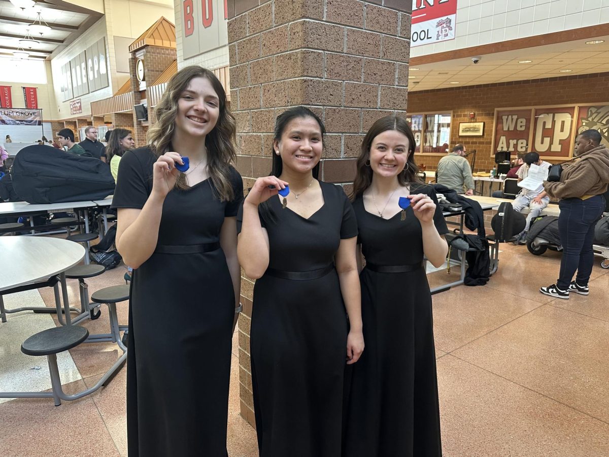 Jaida Frye (10), Roxanne Magtira (10), and Brooklyn Gargano (10) smile for a picture after playing their trio to the song Tango, scoring gold.