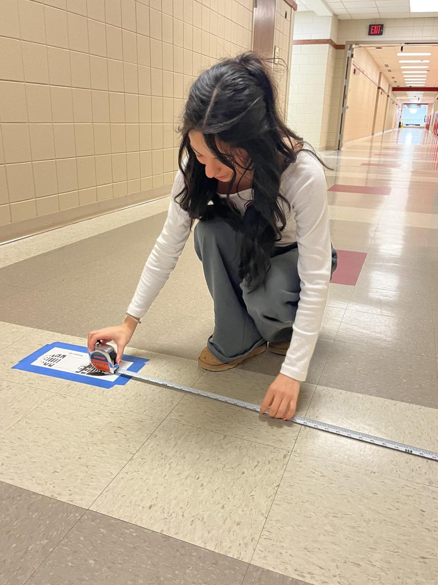 Applying science to solve mysteries, this student is learning how bullet trajectory impacts a crime scene investigation.