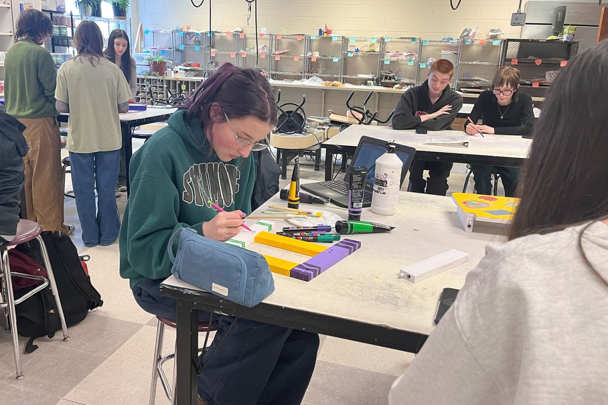 Students paint her chair like a crayon box.  