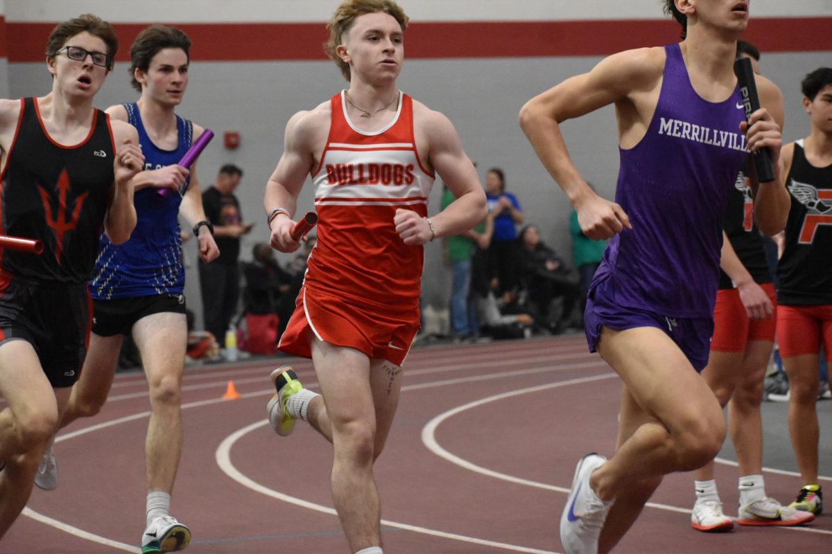 Dane Hayden (12) leads off for the 4x800 meter relay.