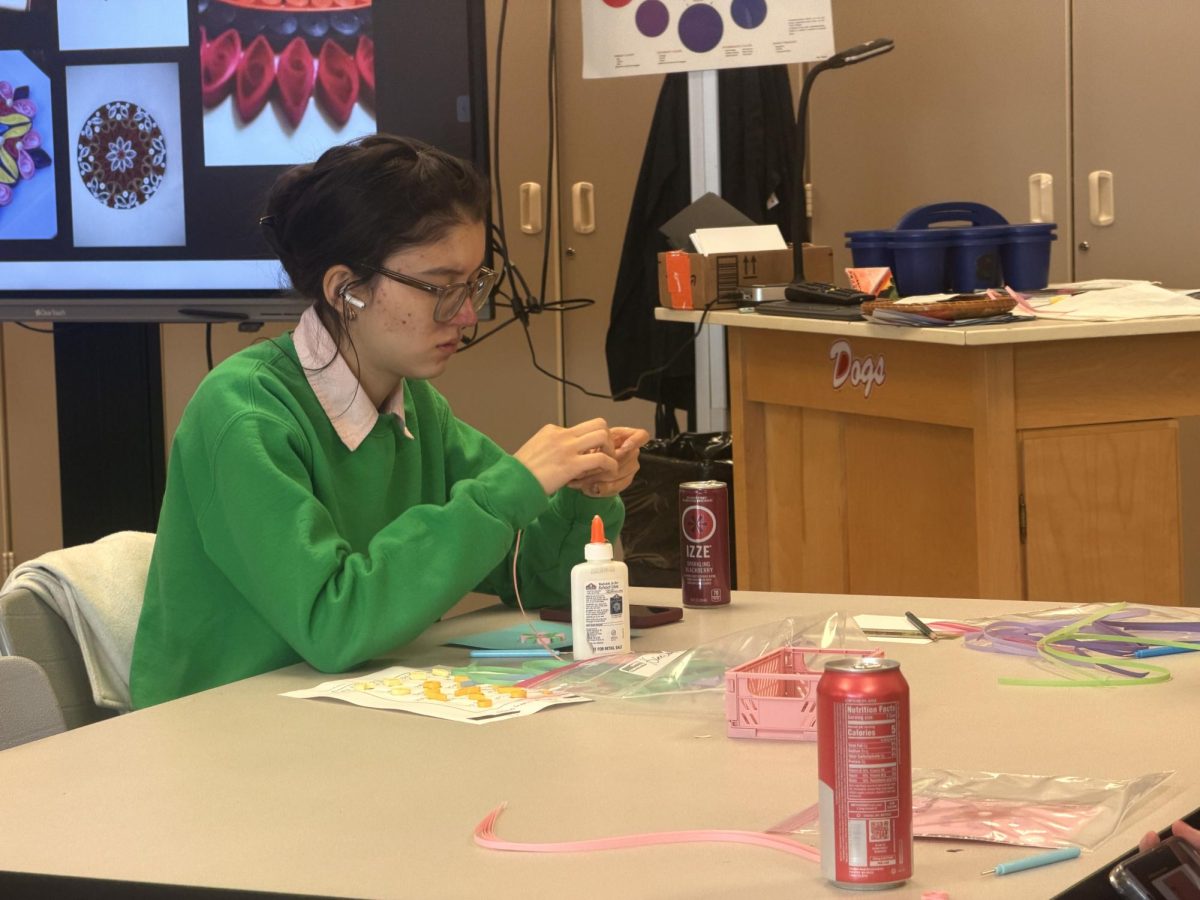 Hwee Chan McCobb (11) works silently on her quilling art piece.