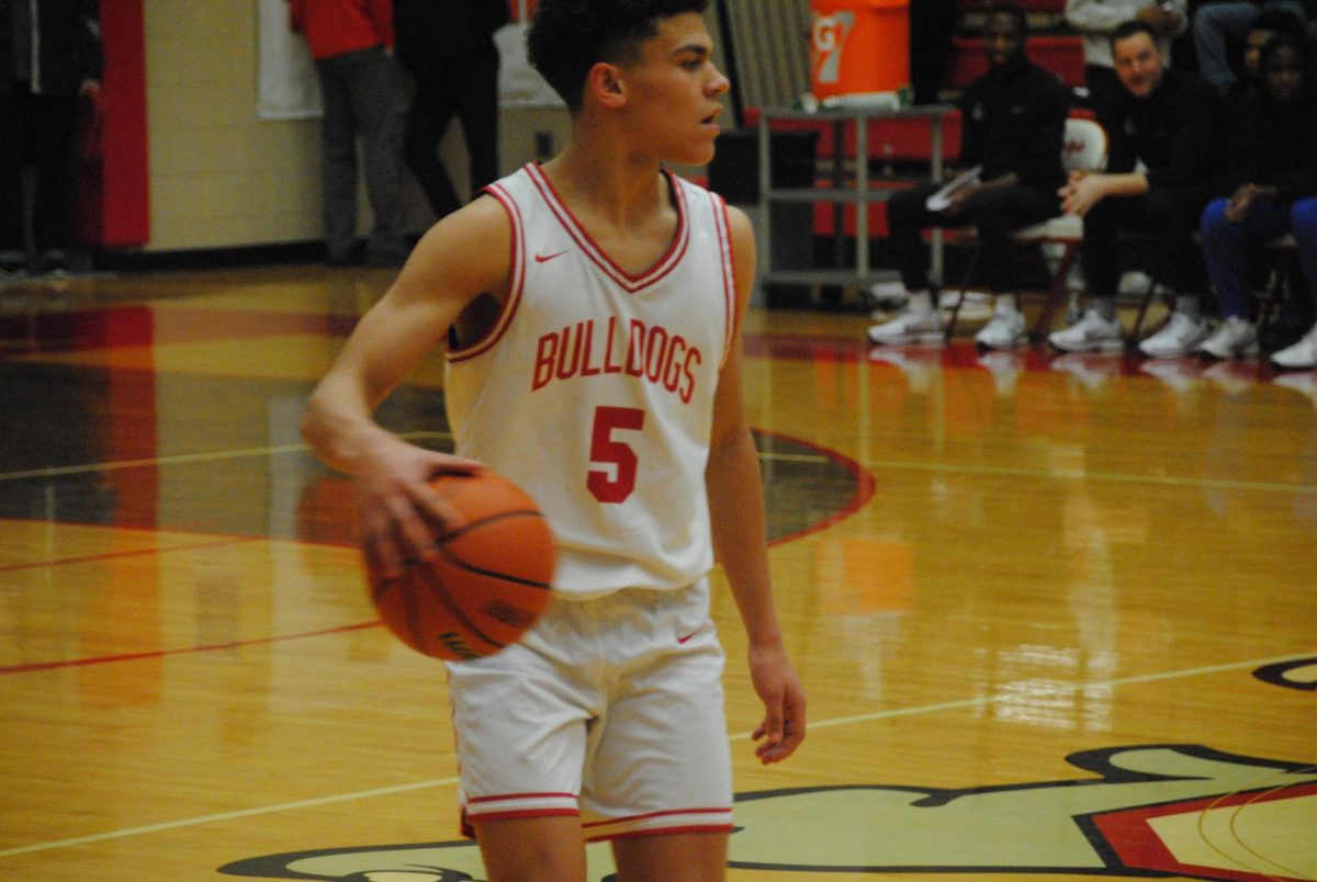 Christian Hughes (9) takes control of the ball at the JV basketball game.