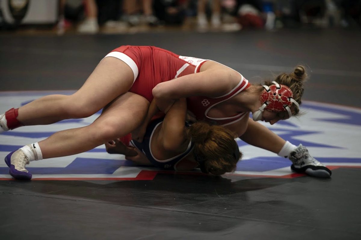 Ava Strayer (10) gets ready to pin her opponent.