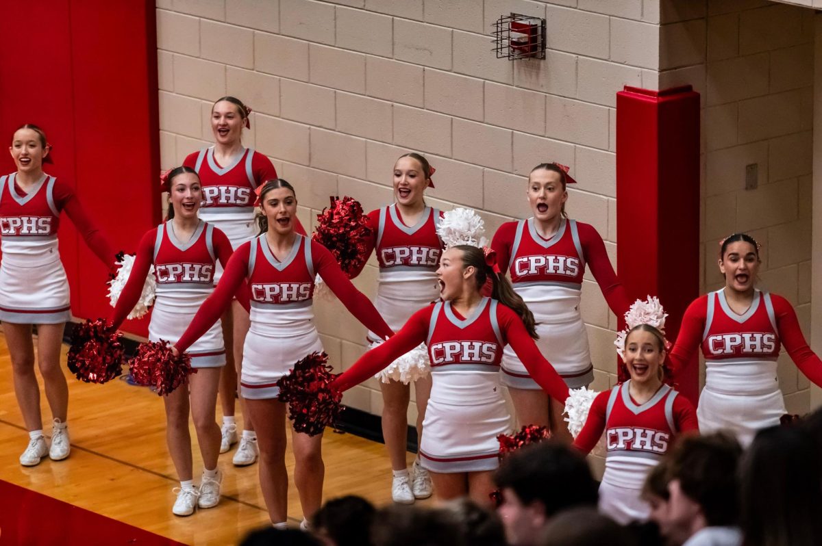 Varsity cheerleaders make sure they are on track with the fast-pace basketball game.