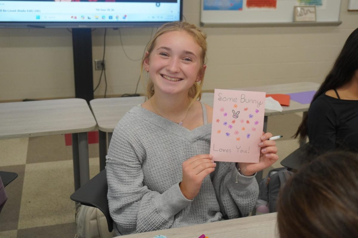 Chelsea Rosenbaum (9) shows the card she is making.