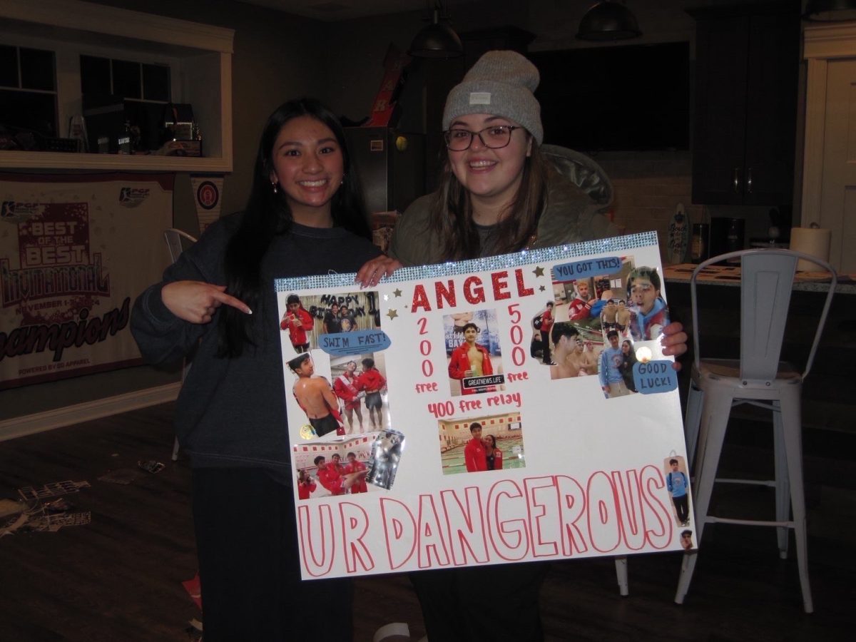 Mika Santos (11) makes a poster with Sophia Rubio (12) for a boy on the swim team.