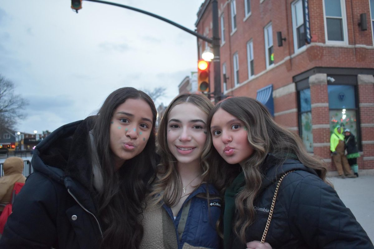 Abigail Cornejo (9) poses with her friends for a photo at the parade with Eva Estrada (9) and Nayeli Fernandez (9).