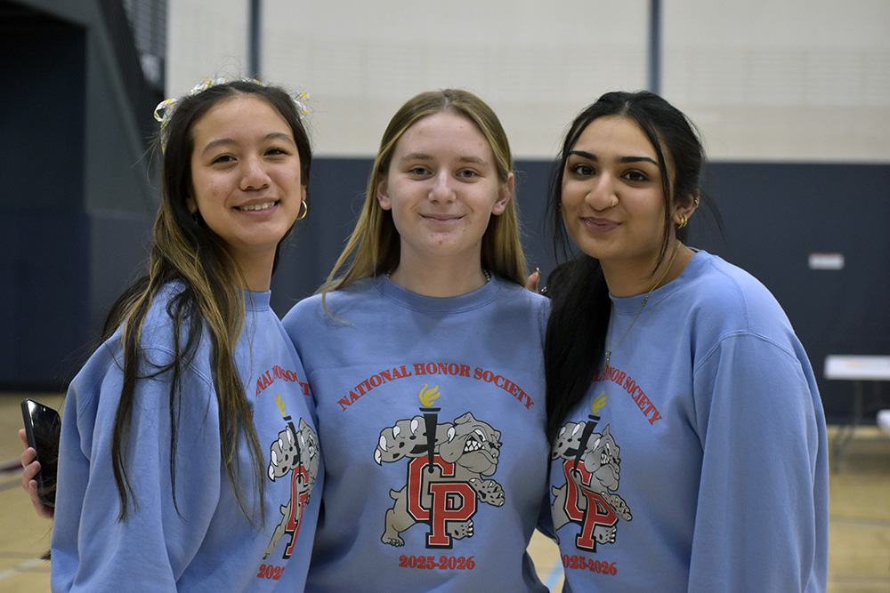 National Honor Society directors Rylee Owen (12), Olivia Wojewoda (12), and Duaa Khan (11) pose for a photo.