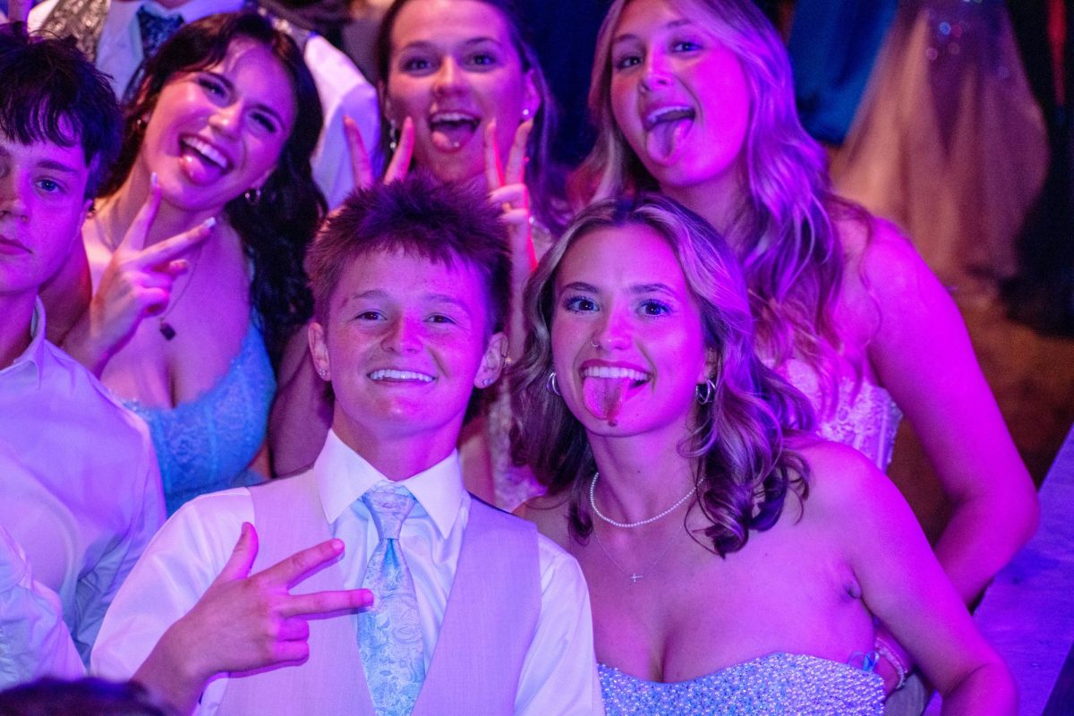 Avery Moore (12) and her date pose for a photo on the dance floor.