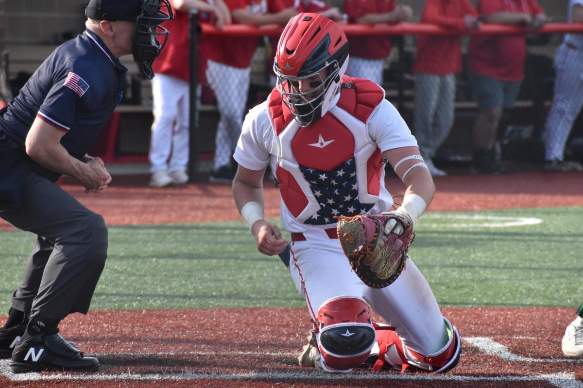 Sean Dunlap (12) catches the ball from the umpire.
