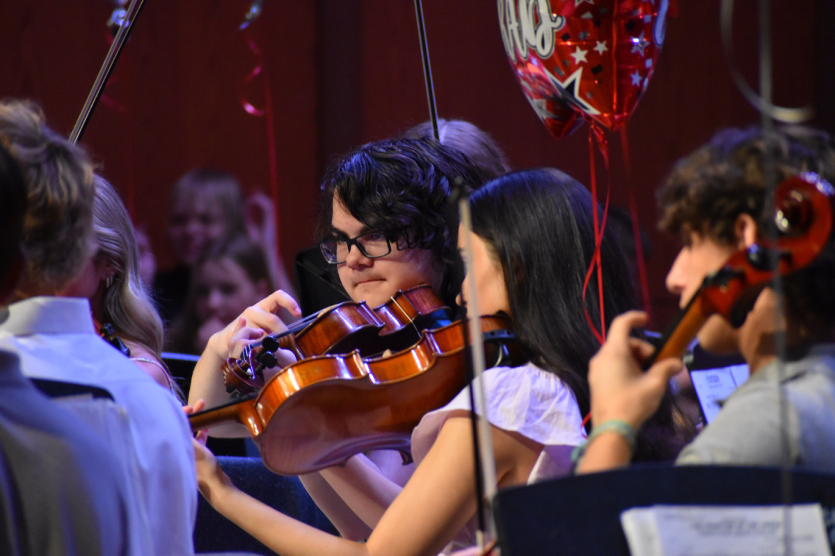 Sophomore Skylar Buckmaster plays his violin.